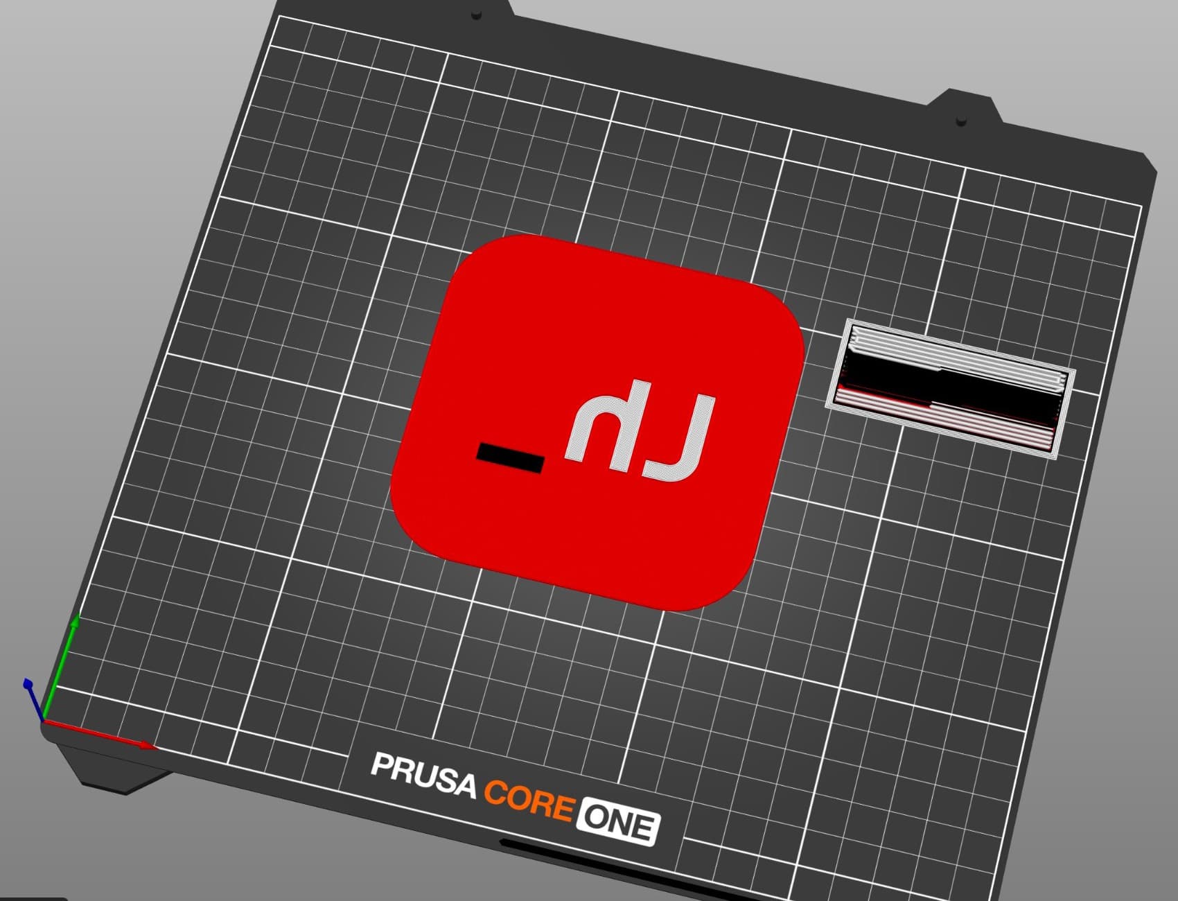 The logo coaster in PrusaSlicer, face down on a Core One build plate, so the logo appears mirrored